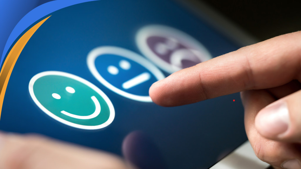 Finger selecting a happy face on a customer satisfaction rating screen